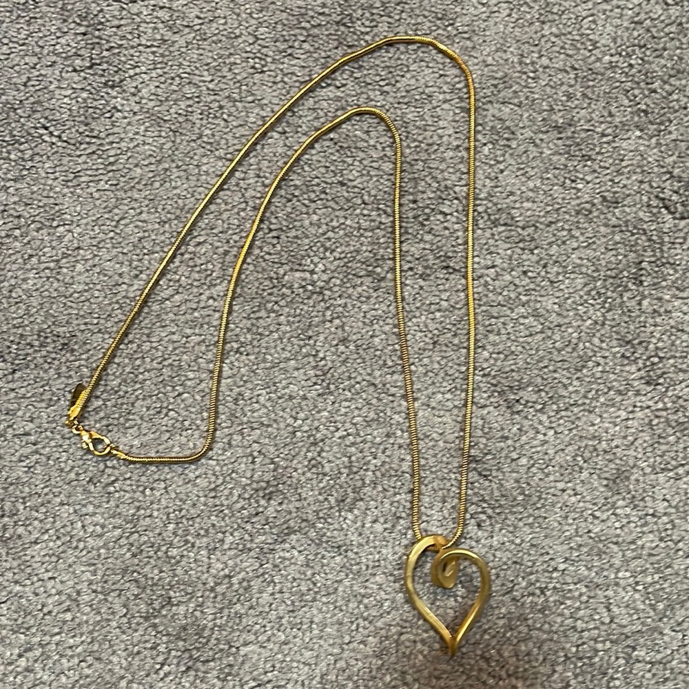 Long brass colored necklace with heart from New York and Company.